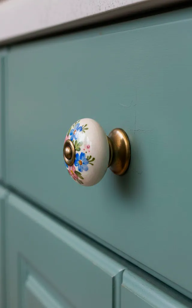 1 vertical realistic close up photo of a teal kitchen cabinet drawer featuring a mismatched hand painted fl 01 filled 640x1024
