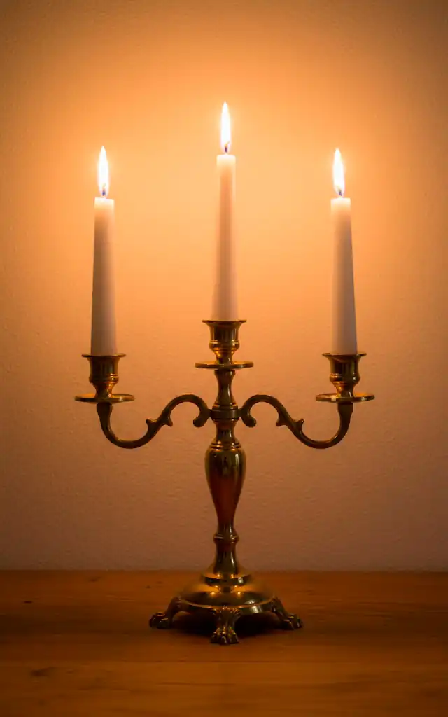 2 a realistic shot of a brass candelabra sitting on a wooden surface with three tall white taper candles th 01 filled