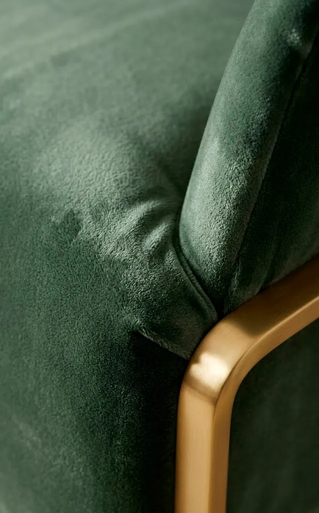 Close-up of plush sage green velvet fabric on a piece of furniture.