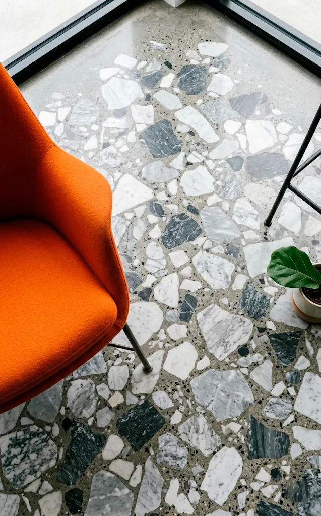 Monolithic terrazzo floor with large marble chips in a modern retro futuristic home.