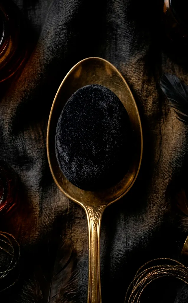 Black velvet Easter egg in a gold spoon.